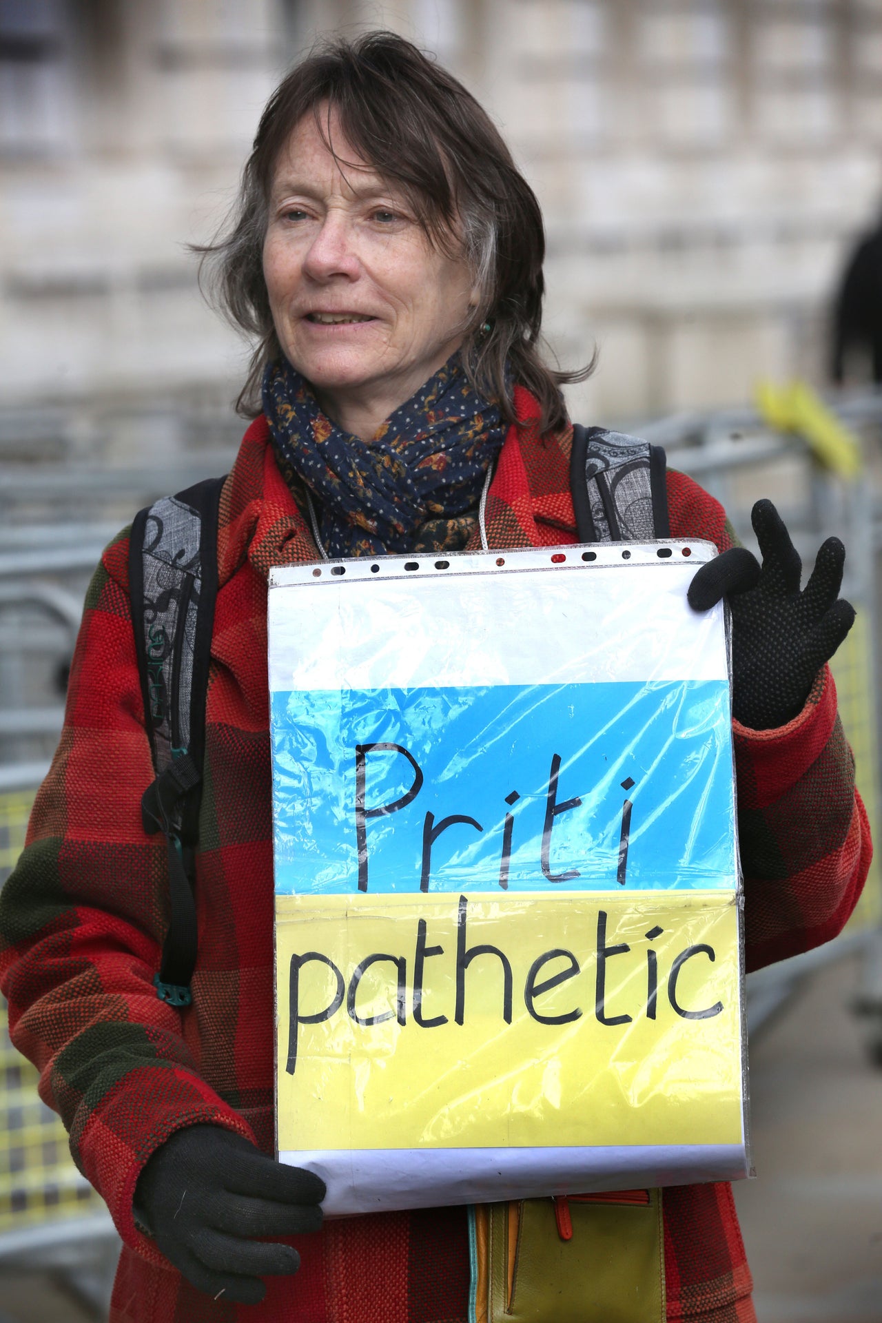 A protester holds up a placard criticising the Home Office response to the refugee crisis sparked by Russia's invasion of Ukraine. 