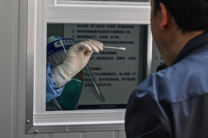 A man is getting tested for COVID-19 near the Shanghai Jin'an Central Hospital on March 14, 2022. 