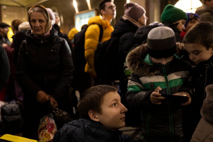 Families queue to board trains to Poland, at the main train terminal on March 14, 2022, in Lviv, Ukraine.