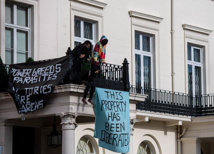 Protesters occupy a building reported to belong to Russian oligarch Oleg Deripsaka on March 14, 2022.