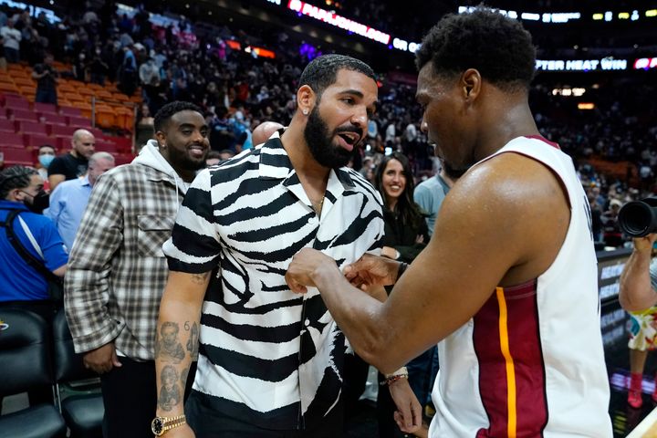 Drake chats with Miami Heat guard Kyle Lowry after a Jan. 14 game in Miami.