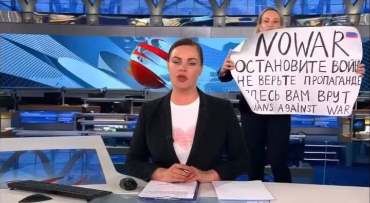 Marina Ovsyannikova holds up an anti-war sign during the evening broadcast of Russia's state-owned Channel One news.