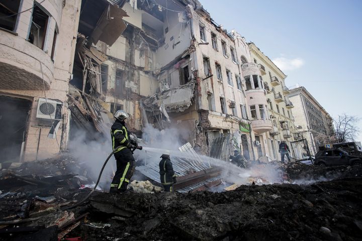 Firefighters extinguish an apartment house after a Russian rocket attack in Kharkiv, Ukraine on Monday.