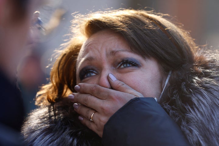 A woman reacts after she was rescued from a residential apartment building that was hit by shelling in Kyiv, Ukraine on Tuesday.
