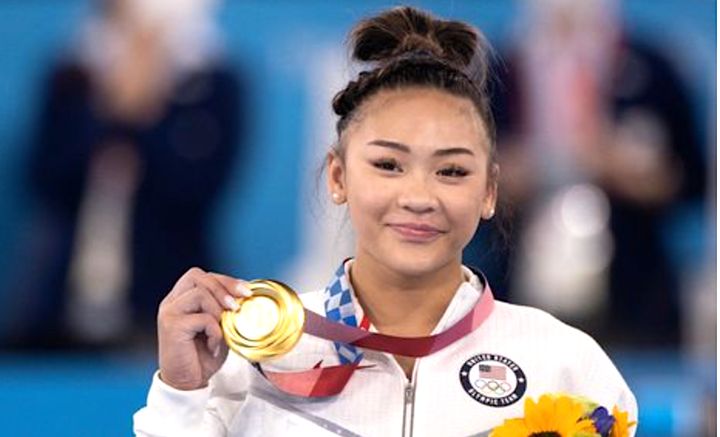 Suni Lee celebrates with her all-around gold medal at the Tokyo Olympics.