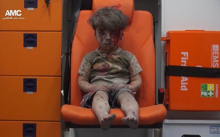 In this Aug. 17, 2016 file frame grab taken from video provided by the Syrian anti-government activist group Aleppo Media Center (AMC), 5-year-old Omran Daqneesh sits in an ambulance after being pulled out of a building hit by an airstrike in Aleppo, Syria. With its missile strike on Shayrat Airbase in central Syria, Washington signaled that it had judged President Bashar Assad responsible for the horrific chemical weapons attack in north Syria that drew international outrage last week.