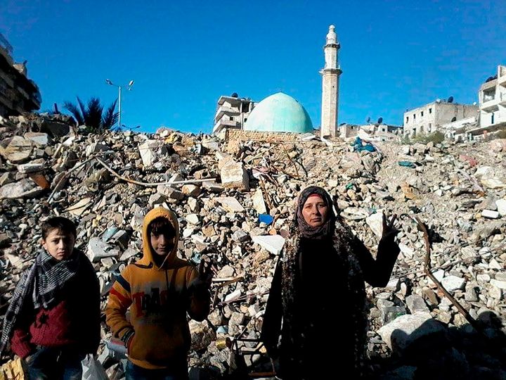 This photo provided by Afraa Hashem in March 2022, shows her, right, with her children Wissam, left, and Zein in the once rebel-held Salaheddine neighborhood in the eastern Aleppo, Syria. Hashem and other Aleppo survivors on Tuesday, March 15, 2022, mark the 11th anniversary of Syria's revolution-turned-civil war. This year, many survivors are watching in shock as Ukrainians face the same horrors they did.