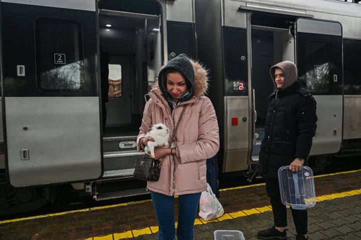 A woman carries a pet rabbit as she exits a train arriving from Kyiv on February 23, 2022 in Przemysl, Poland. (Omar Marques/Getty Images)