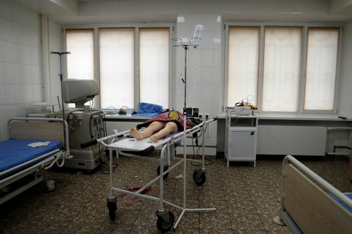 The lifeless body of a girl killed during shelling at a residential area lies on a medical cart at the city hospital of Mariupol, eastern Ukraine, on Feb. 27, 2022.