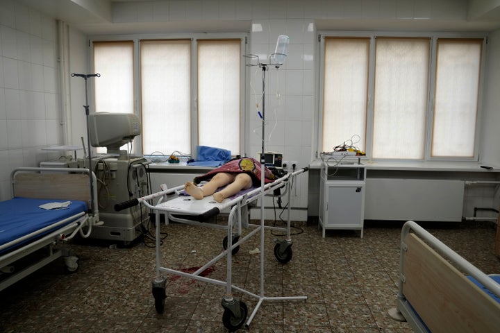 The lifeless body of a girl killed during shelling at a residential area lies on a medical cart at the city hospital of Mariupol, eastern Ukraine, on Feb. 27, 2022. 