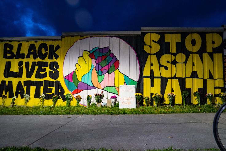 Members of the Bad Asian and Civic Walls groups paint a mural near Krog Street Tunnel on March 21, 2021, in Atlanta, Georgia.