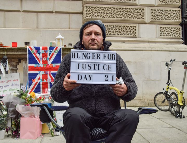 Richard Ratcliffe holds a 'Hunger For Justice' sign on the 21st and final day of his hunger strike outside the Foreign, Commonwealth and Development Office.