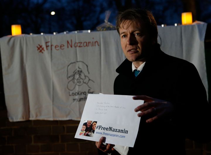 Richard Ratcliffe talks to the media as he holds a letter for the Iranian president and cards for his wife during an vigil outside the Iranian Embassy in London in 2017.