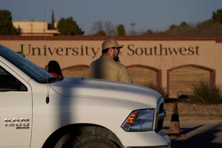 A security guard stands at the entrance to the University of the Southwest, Wednesday, March 16, 2022, in Hobbs, N.M. 