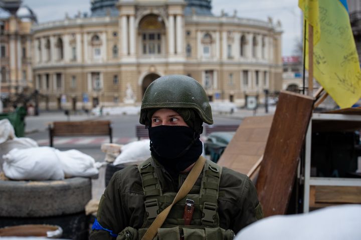 A soldier stands guard as Ukrainians place sandbags and anti-tank barriers to protect historic landmarks in expectation of a Russian assault (Photo by Scott Peterson/Getty Images)