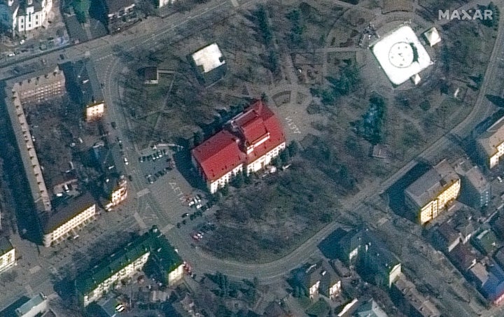 This satellite image provided by Maxar Technologies shows the Mariupol Drama Theater on Monday, March 14, with the Russian word for "children" written on the ground outside.