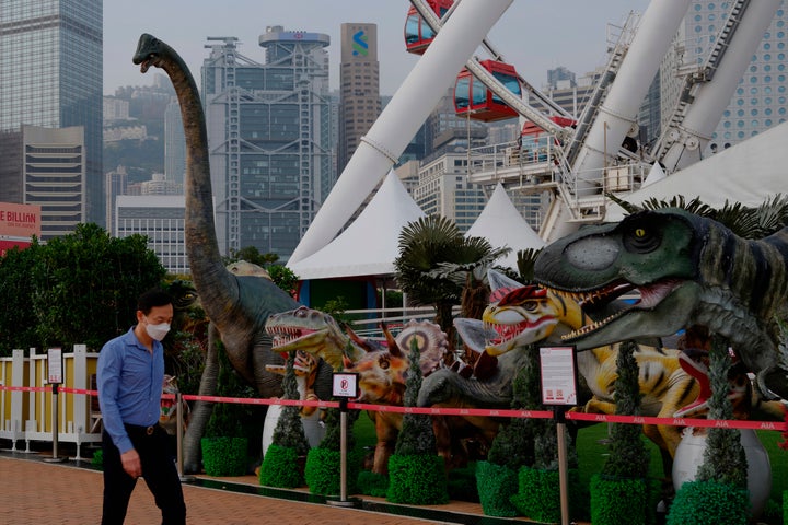 A man wearing face mask walks in the Central district in Hong Kong on March 18, 2022.