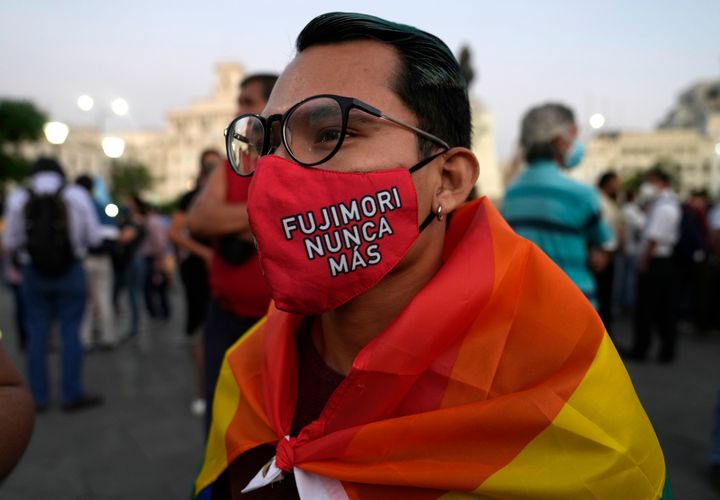 A young man wears a mask against the spread of the new coronavirus that has text that reads in Spanish "Fujimori never more," as demonstrators protest against the decision of Peru's Constitutional Court approving the release from prison of former President Alberto Fujimori in Lima, Peru, on March 17, 2022.