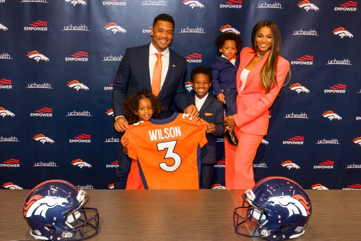 Russell Wilson pictured with Ciara and their children, (from left to right) Sienna, Future and Win, following an introductory press conference on March 16, 2022 in Englewood, Colorado.