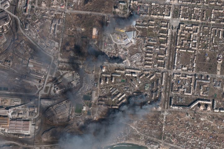 In this satellite photo, multiple civilian buildings burn amid Russian strikes on the Livoberezhnyi District of Mariupol, Ukraine on Sunday, March 20, 2022. 