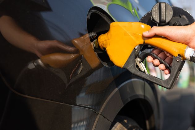 Close-up of hand holding fuel nozzle