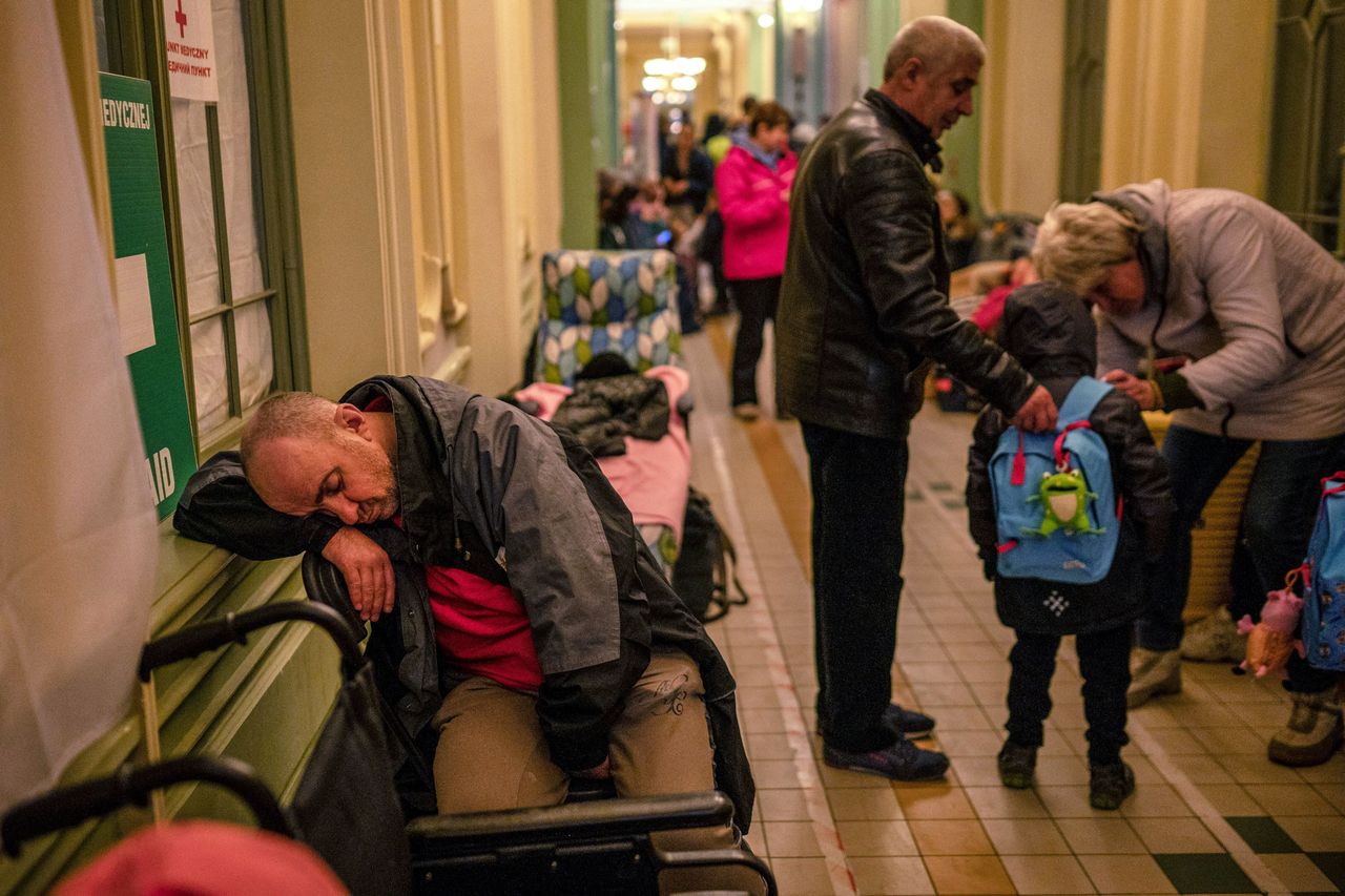 A Ukrainian evacuee sleeps in the hall of the main railway station in Przemysl, near the Polish-Ukrainian border.