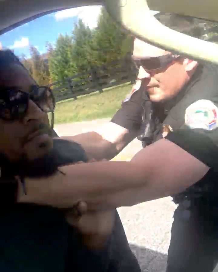 In this image made from video provided by Delane Gordon, a police officer in Collegedale, Tenn., is seen trying to remove Gordon from his vehicle before he fires a stun gun at Gordon.
