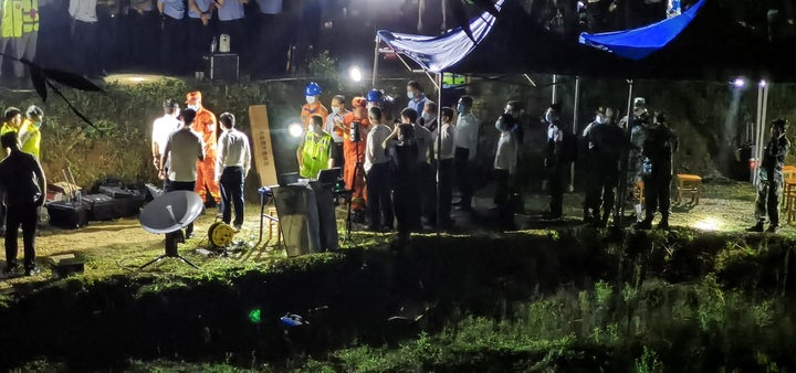 This photo taken on March 21, 2022 shows rescuers working at the site of a plane crash in Tengxian county, Wuzhou city, in China's southern Guangxi region. - A China Eastern passenger jet carrying 132 people crashed onto a mountainside in southern China on March 21 causing a large fire, shortly after losing contact with air traffic control and dropping thousands of metres in just three minutes. - China OUT (Photo by AFP) / China OUT (Photo by STR/AFP via Getty Images)