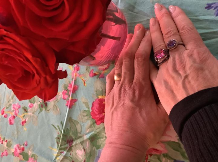 The author and her husband's hands, wearing their new wedding rings, on their wedding day.
