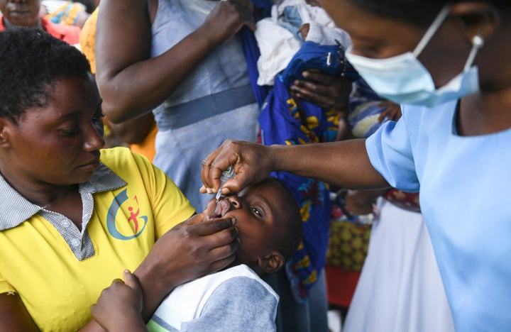 A child receives a polio vaccine, during the Malawi Polio Vaccination Campaign Launch in Lilongwe Malawi, Sunday March 20, 2022. A drive to vaccinate more than 9 million children against polio has been launched this week in four countries in southern and eastern Africa after an outbreak was confirmed in Malawi. (AP Photo/Thoko Chikondi)