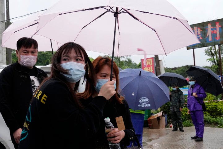 Relatives of passengers onboard the China Eastern Flight 5735 leave the village near the crash site in southwestern China's Guangxi province on March 23, 2022.