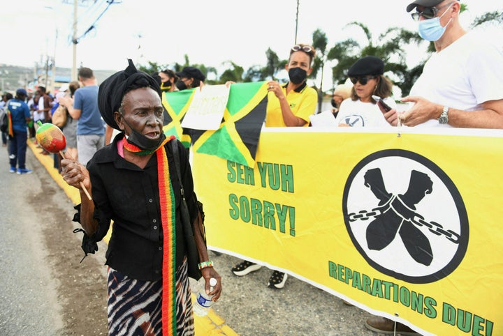 People calling for slavery reparations, protest outside the entrance of the British High Commission during the visit of the Duke and Duchess of Cambridge in Kingston, Jamaica on March 22.