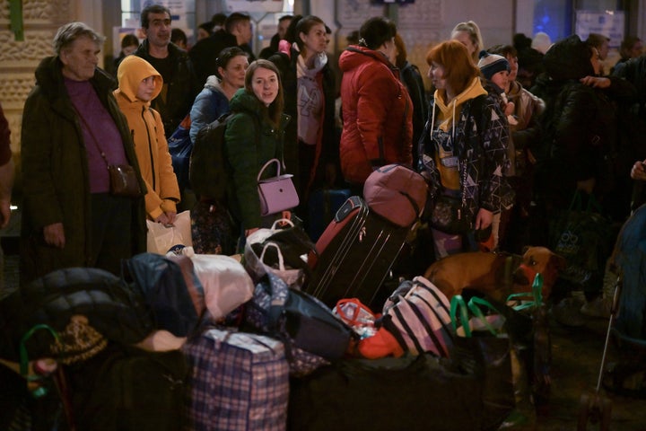 People, mainly women and children, board coaches at Przemysl station in Poland as they continue their onward journey from war-torn Ukraine on March 23, 2022.
