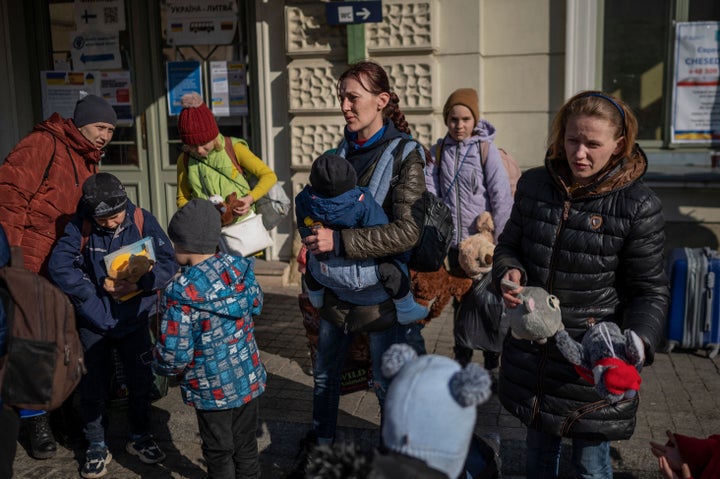 Women with children are seen outside the main railway station in Przemysl, southeastern Poland near the Polish-Ukrainian border, as refugees from Ukraine wait to get on buses to other destinations in Poland, on March 24, 2022.