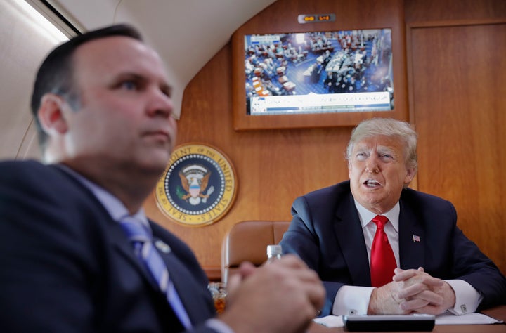 President Donald Trump, on board Air Force One, watches a live television broadcast of the Senate confirmation vote of Supreme Court nominee Brett Kavanaugh on Oct. 6, 2018. Sitting in front of Trump is White House director of social media Dan Scavino. (AP Photo/Pablo Martinez Monsivais)