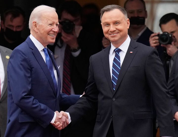 U.S. President Joe Biden, left, and Polish President Andrzej Duda shake hands during a military welcome ceremony at the Presidential Palace in Warsaw, Poland, on Saturday, March 26, 2022.