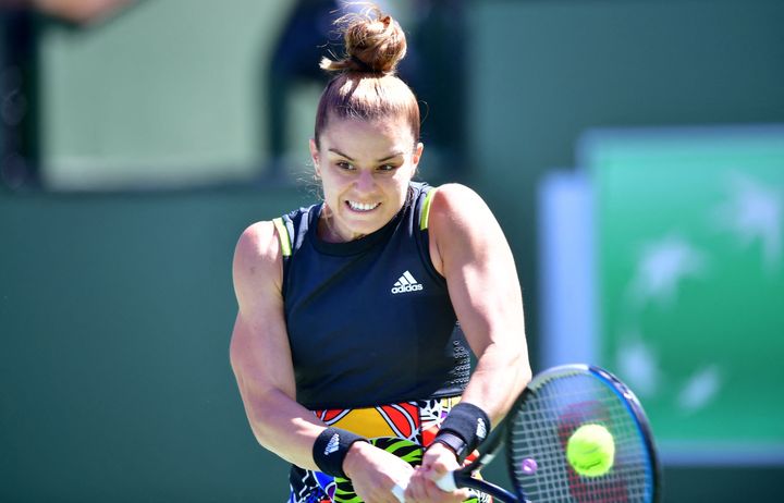 Maria Sakkari of Greece plays a backhand return to Iga Swiatek of Poland in their ATP Men's Final at the Indian Wells tennis tournament on March 20, 2022 in Indian Wells, California. - Former French Open champion Iga Swiatek beat Maria Sakkari 6-4, 6-1 on Sunday to win the WTA Indian Wells title and move to a career-high ranking of number two in the world.Swiatek's fifth career title was her second in as many tournaments after her triumph in Doha last month, and pushed her WTA match-win streak to 11. (Photo by Frederic J. BROWN / AFP) (Photo by FREDERIC J. BROWN/AFP via Getty Images)