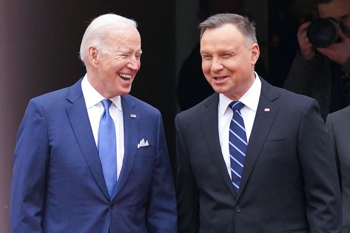 US President Joe Biden (L) and Polish President Andrzej Duda shake react during an official wecoming ceremony prior to a meeting in Warsaw on March 26, 2022.