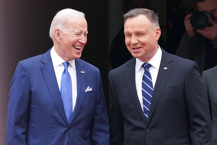 US President Joe Biden (L) and Polish President Andrzej Duda shake react during an official wecoming ceremony prior to a meeting in Warsaw on March 26, 2022.