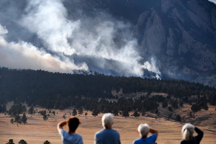 Residents of Eldorado Springs watch as the NCAR fire burns in the foothills south of the National Center for Atmospheric Research in Boulder, Colorado. So far 122 acres have burned, more than 19,000 people have evacuated and there are 8000 homes in the evacuation area. The fire is currently 0% contained.