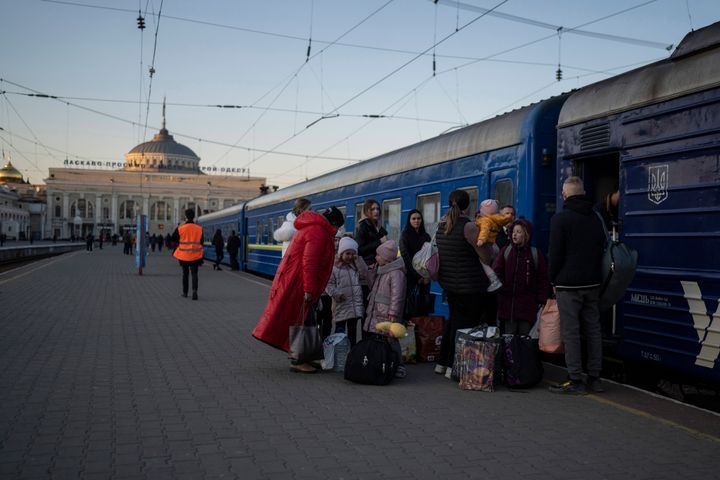 People embark a train in Odesa, southern Ukraine, on March 23, 2022. (AP Photo/Petros Giannakouris, File)