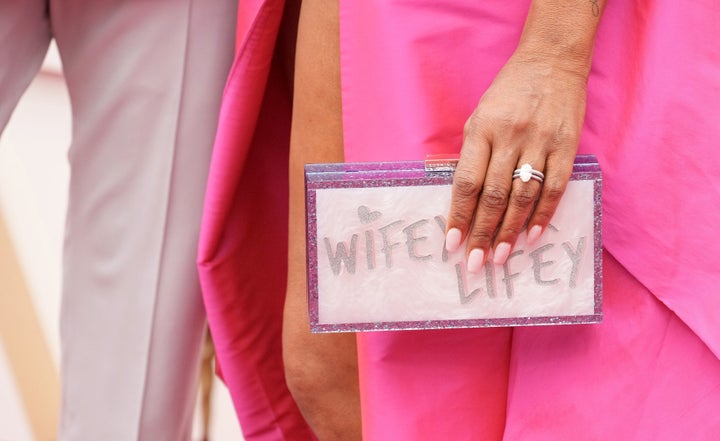 Nash carries a “Wifey For Lifey” clutch on the red carpet.