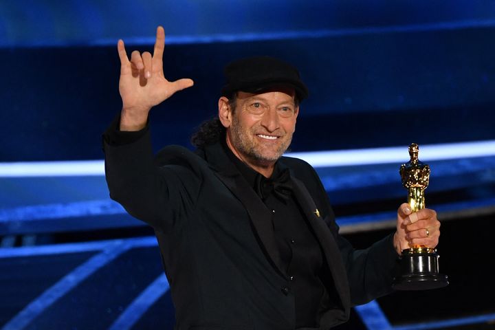 Troy Kotsur accepts the award for Best Actor in a Supporting Role for "CODA" onstage during the 94th Oscars.