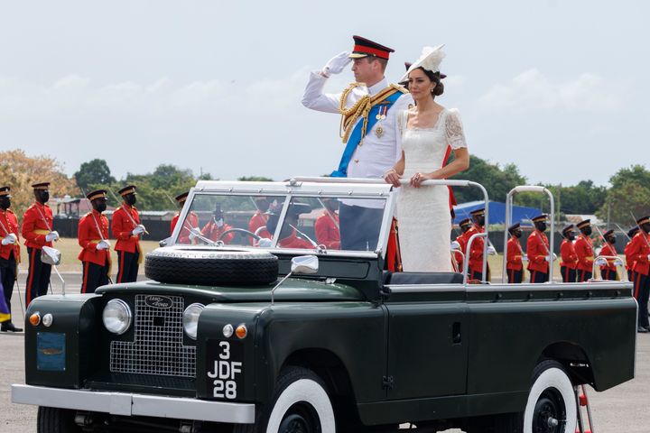 Catherine, Duchess of Cambridge and Prince William, Duke of Cambridge ride in a Land Rover.