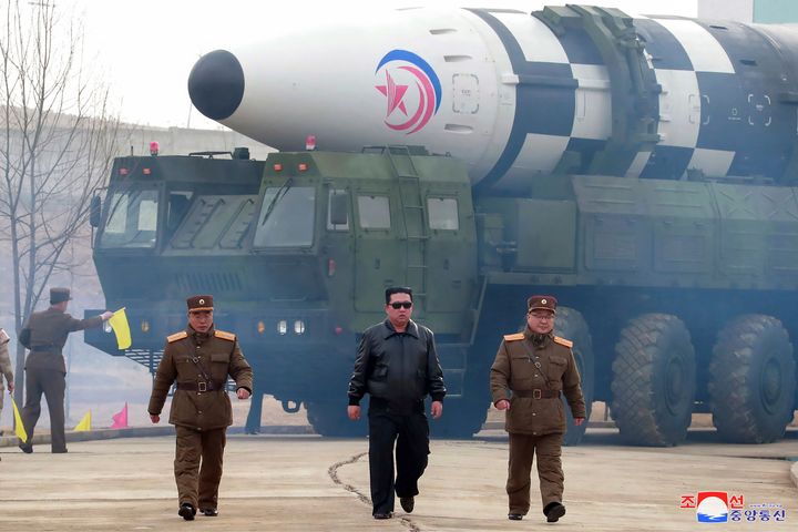 In this photo distributed by the North Korean government, North Korean leader Kim Jong Un, center, walks around what it says a Hwasong-17 intercontinental ballistic missile (ICBM) on the launcher, at an undisclosed location in North Korea on March 24, 2022. Independent journalists were not given access to cover the event depicted in this image distributed by the North Korean government. 