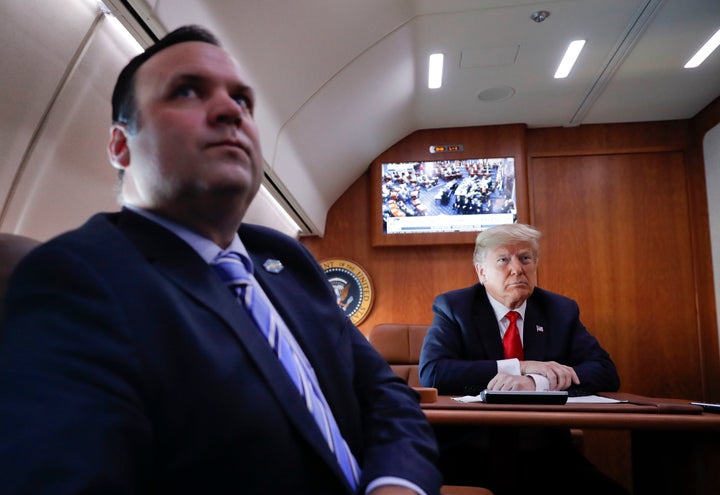 President Donald Trump, on board Air Force One, watches a television broadcast of the Senate confirmation vote of Supreme Court nominee Brett Kavanaugh, Oct. 6, 2018.