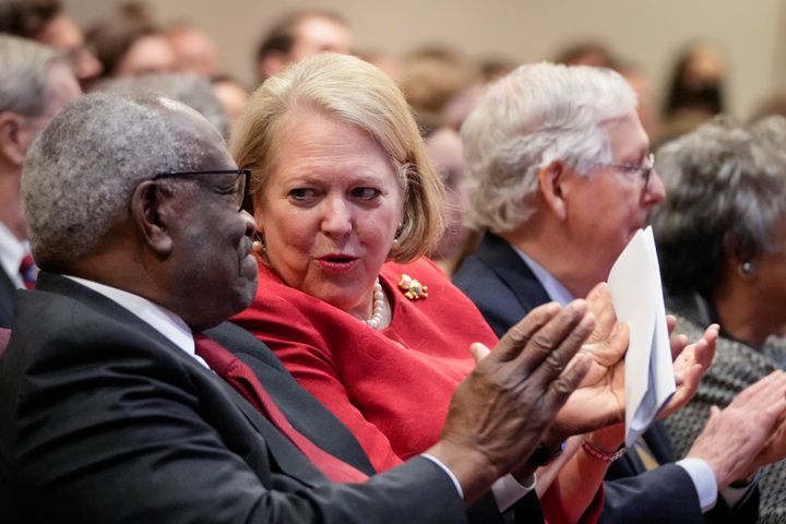 Associate Supreme Court Justice Clarence Thomas sits with his wife, conservative activist Virginia "Ginni" Thomas, while he waits to speak at the Heritage Foundation on Oct. 21, 2021.
