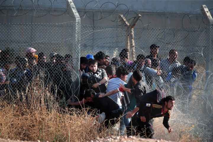 Syrian refugees cross into Turkey after breaking the border fence on June 14, 2015. Arab and Muslim refugees are often turned away or treated with suspicion in the West, even when fleeing conflicts in which Western countries played a prominent role.