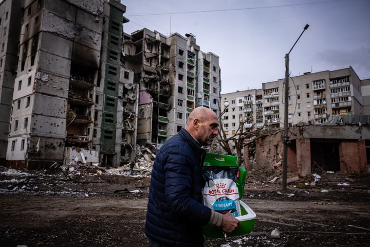 A man walks in front of a residential building damaged in the shelling in the city of Chernihiv on March 4, 2022.