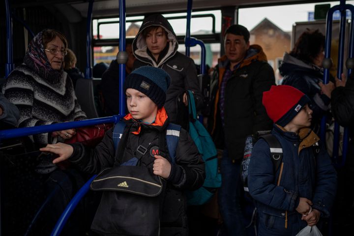 Ukrainian refugees wait on a bus after crossing the Ukrainian border with Poland at the Medyka border crossing. 